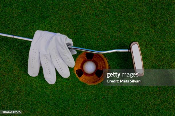 golf glove with golf ball and putter - putting gloves stock pictures, royalty-free photos & images