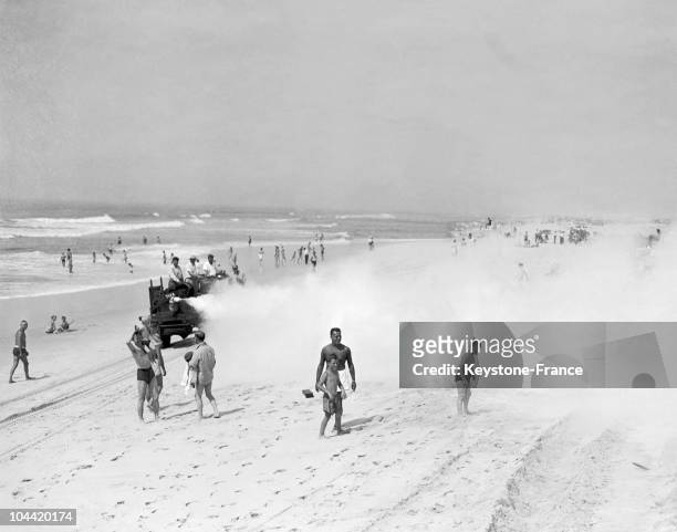 In 1945, A Truck Spraying Ddt On Jones Beach, Long Island To Eliminate Mosquitoes. The People On The Beach Do Not Seem Worried About The Toxicity Of...