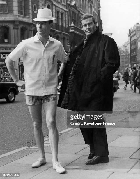 Two Models Presenting Items From Cecil Gee'S Fall Collection, In London On May 19, 1965. On The Left, A Grey/White Ensemble With Tennis Shoes And On...