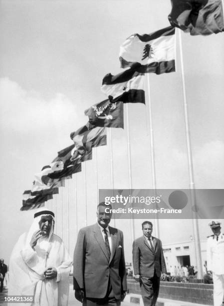 Sheikh Abdullah Al Salem Al Sabah The Kuwait Ruler, Accompanied By President Nasser Walking Out Of The Airport With The Flags Of The 13 Arab States,...