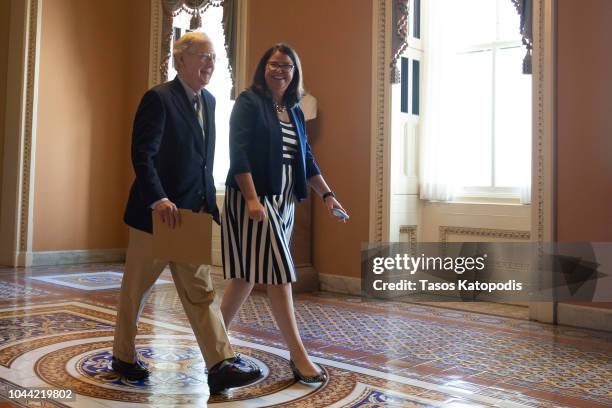 Senate Majority Leader Sen. Mitch McConnell and Secretary for the Majority Laura Dove head to the senate floor on October 1, 2018 in Washington, DC.