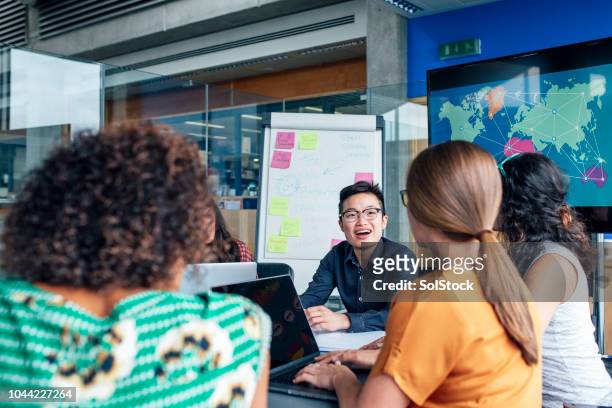 diverse chinese businesswoman heading up meeting - to assemble world stock pictures, royalty-free photos & images