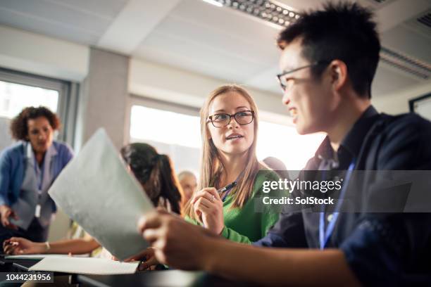 female university students discuss presentation, very real - university debate stock pictures, royalty-free photos & images