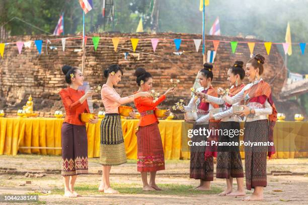 thai girls and laos girls splashing water during festival songkran festival - heritage festival presented stock pictures, royalty-free photos & images