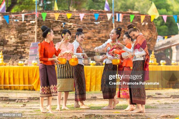 thai girls and laos girls splashing water during festival songkran festival - heritage festival presented stock pictures, royalty-free photos & images