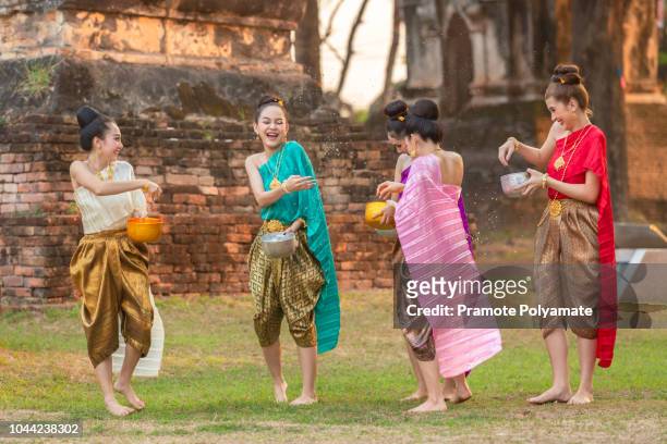 thai girls and laos girls splashing water during festival songkran festival - songkran festival stock-fotos und bilder