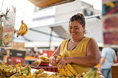 Portrait of confident owner - Selling bananas at farmers market