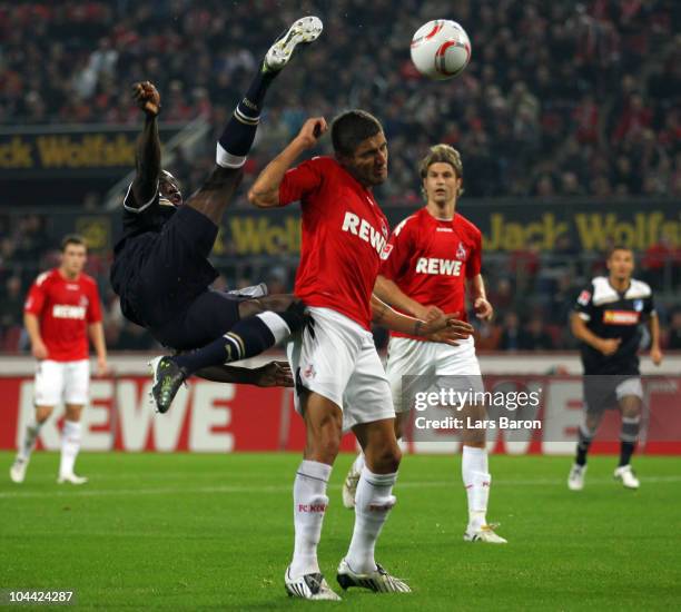 Demba Ba of Hoffenheim makes a overhead kick next to Youssef Mohamad of Koeln during the Bundesliga match between 1. FC Koeln and 1899 Hoffenheim at...