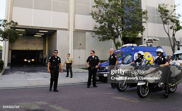 Members of Beverly Hills Police Department wait outside the side exit of Beverly Hills courthouse to escort actress Lindsay Lohan on September 24,...