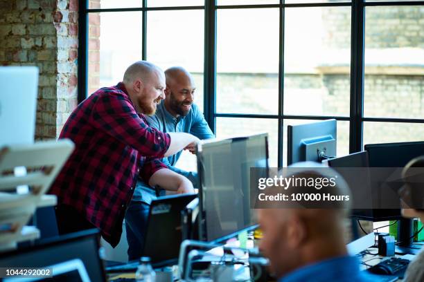 busy modern creative office with design professionals and computers - agence-de-design photos et images de collection