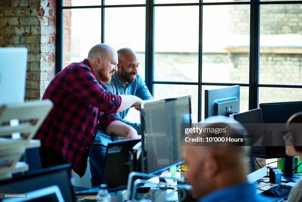 Busy modern creative office with design professionals and computers