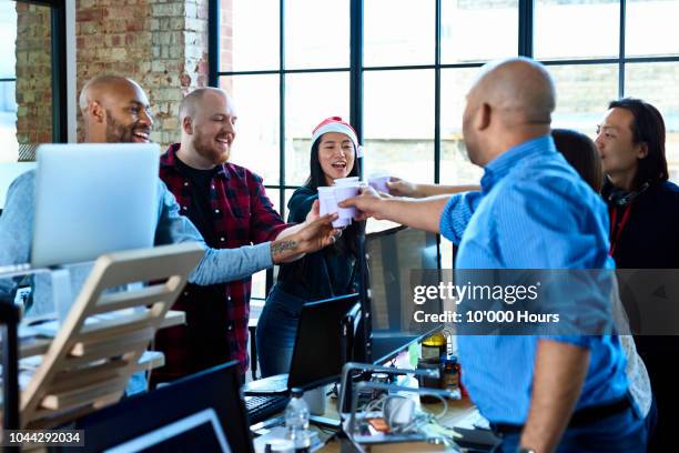 office colleagues toasting at work with plastic cups - christmas party office stockfoto's en -beelden