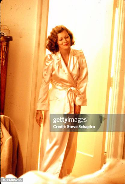 American actress Faye Dunaway, in a dressing gown, as she stands in a doorway on the set of the film 'Chinatown' , Los Angeles, California, 1973.
