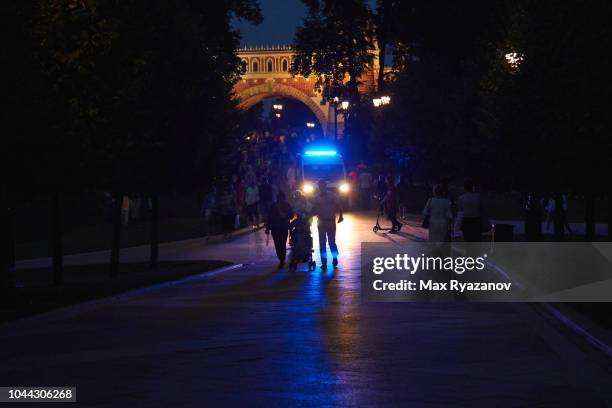 the ambulance is moving through the pedestrian zone at dusk. - ambulance lights stock pictures, royalty-free photos & images