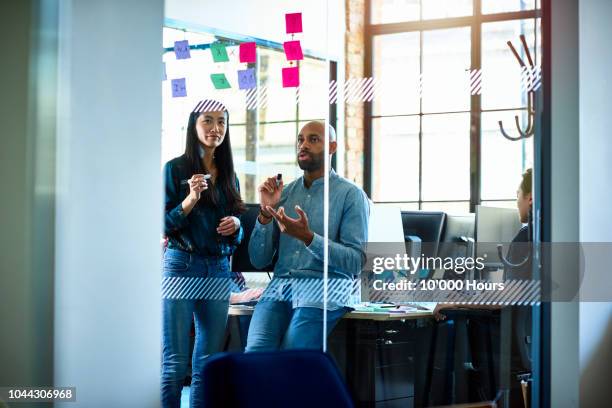 two business people discussing in modern office with sticky notes - london 2018 day 2 bildbanksfoton och bilder