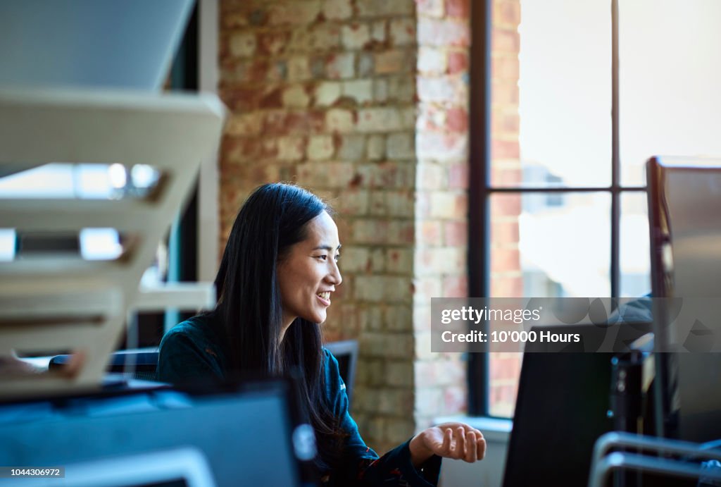 Portrait of mid adult Chinese woman working at desk