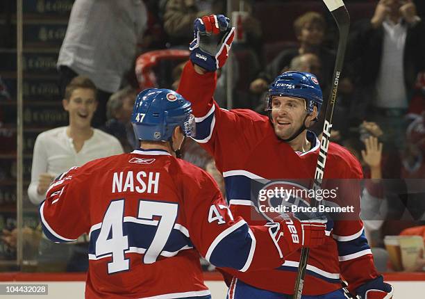 Brendan Nash of the Montreal Canadiens congratulates Mathieu Darche on his power goal at 15:50 of the second period against the Ottawa Senators at...