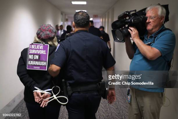 Capitol Police arrest protesters who were demonstrating against the confirmation of Supreme Court nominee Brett Kavanaugh in the Hart Senate Office...