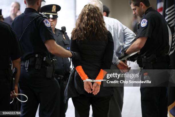 Capitol Police arrest protesters who were demonstrating against the confirmation of Supreme Court nominee Brett Kavanaugh in the Hart Senate Office...