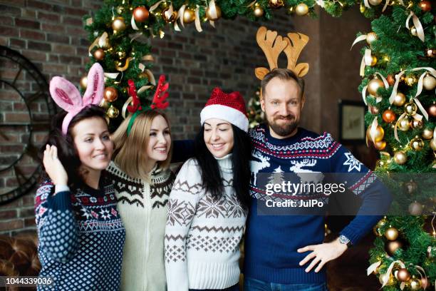 friends celebrating christmas at home - christmas jumper stock pictures, royalty-free photos & images