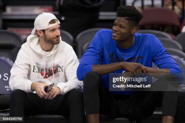 Shooting coach and CEO of Pure Sweat, Drew Hanlen, talks to Mohamed Bamba of the Orlando Magic prior to the preseason game against the Philadelphia...