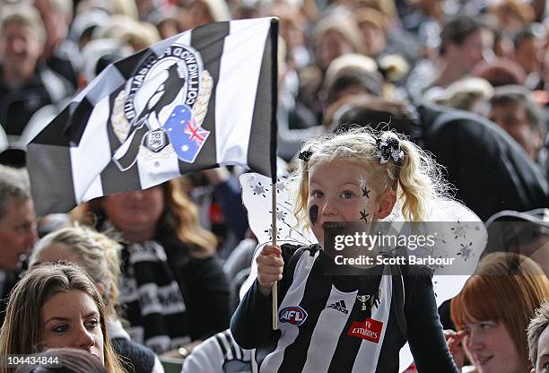 Collingwood fans watch the AFL Grand Final match between the Collingwood Magpies and the St Kilda Saints on a large television screen at the...