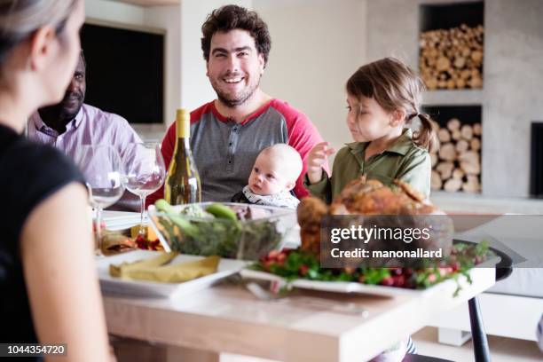 holiday season family and friends multi-ethnic during thanksgiving dinner - fathers day dinner stock pictures, royalty-free photos & images