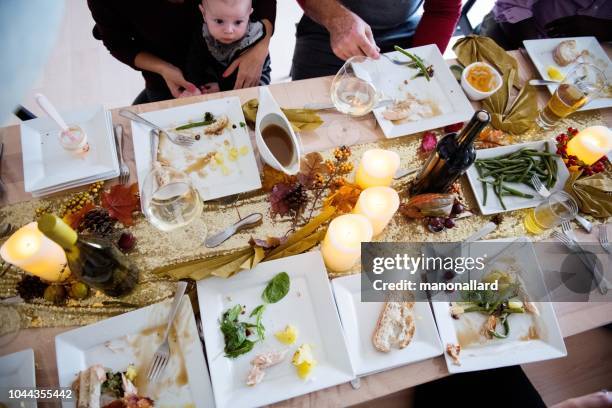 holiday season family and friends multi-ethnic during thanksgiving dinner - after party mess stock pictures, royalty-free photos & images