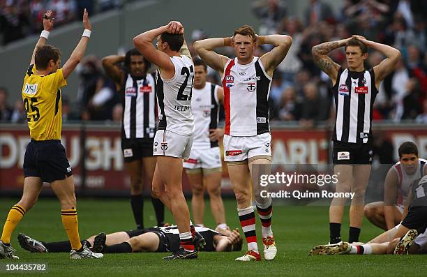Jason Blake and Brendon Goddard of the Saints and Dayne Beams of the Magpies react as the siren sounds at the end of the game and it is a draw during...