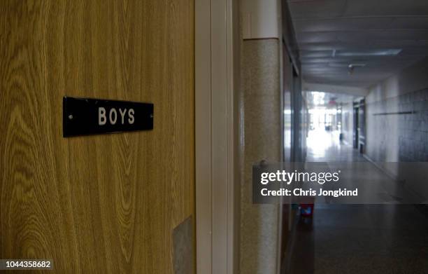 boys restroom door in empty school hallway - toilet door stock pictures, royalty-free photos & images