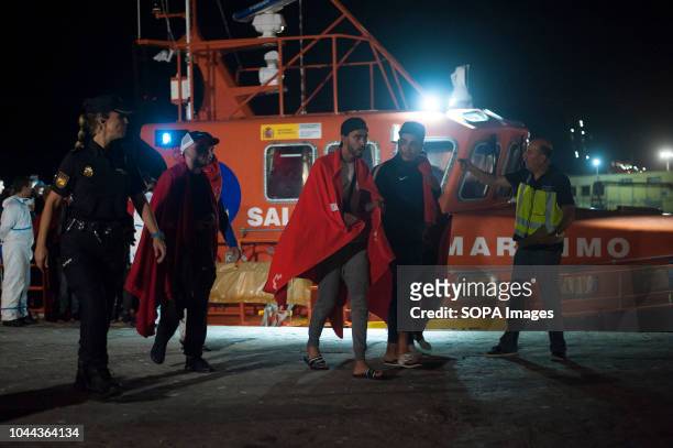 Moroccan and algerian migrants disembark from a rescue boat after their arrival at the Port of Malaga. Spains Maritime Rescue service rescued 96...