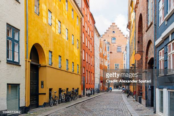 magaestrade street with colorful houses and cobblestone in copenhagen, denmark - morning city stock pictures, royalty-free photos & images