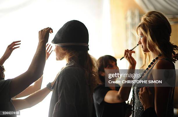 Models are getting ready backstage prior the Elena Miro spring-summer 2011ready-to-wear collection on September 22, 2010 during the Women's fashion...