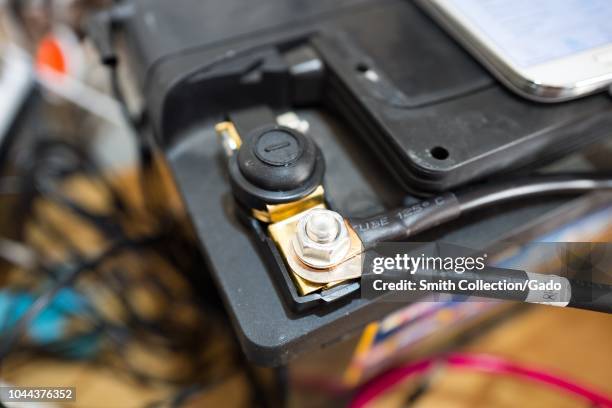 Close-up of screen terminal with wires on the negative terminal of a 12 volt solar photovoltaic battery bank, part of a smart home off grid solar...