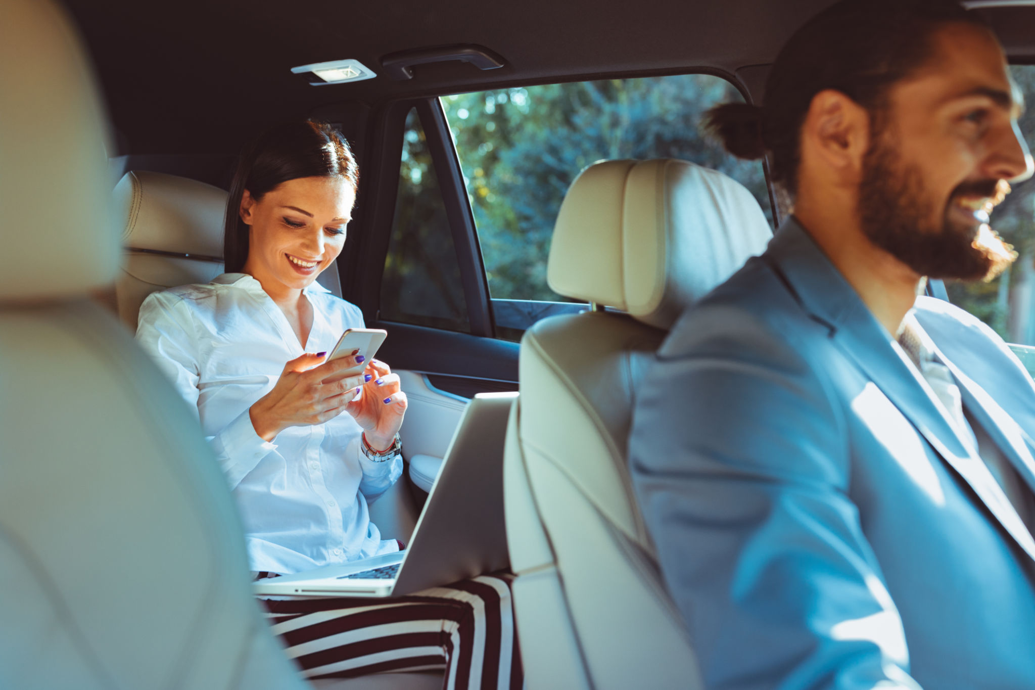 Chauffeur driven limousine with the business woman in the back seat Chauffeur driven limousine with the business woman in the back seat