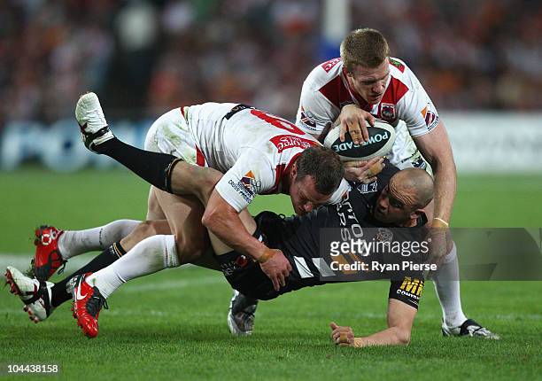 Dean Young and Ben Creagh of the Dragons tackle Liam Fulton of the Tigers during the Second NRL Preliminary Final match between the St George...