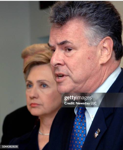 Senator Hillary Clinton listens to Representative Peter King question homeland security funding at a meeting in Lindenhurst, New York on June 3, 2006.