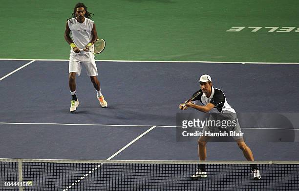 Rogier Wassen of Netherlands plays a backhand with team mate Dustin Brown of Jamaica looking on during their doubles semi final match against Wesley...