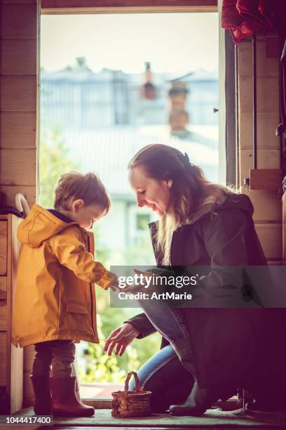 good rainy day for a walk - mother protecting from rain stock pictures, royalty-free photos & images