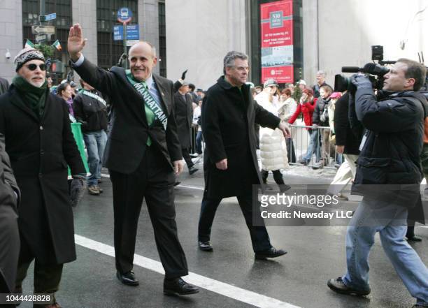 Former NYC mayor Rudy Giuliani waves to the crowd as he marches with Peter King in the St. Patrick's Day Parade on Fifth Avenue in Manhattan on March...