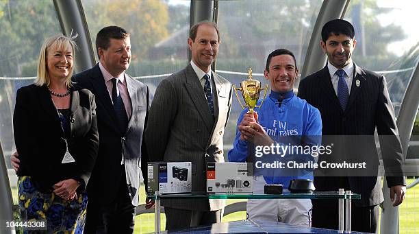 Frankie Dettori lifts the cup after riding Poet's Voice, trained by Saeed bin Suroor , to victory in the Queen Elizabeth II Stakes at Ascot...