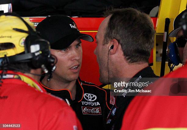 Denny Hamlin , driver of the FedEx Express Toyota, yells at Kevin Harvick, driver of the Shell/Pennzoil Chevrolet, in the garage after an incident on...