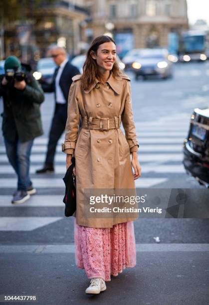 Alexa Chung wearing belted trench coat, maxi dress seen outside Stella McCartney during Paris Fashion Week Womenswear Spring/Summer 2019 on October...