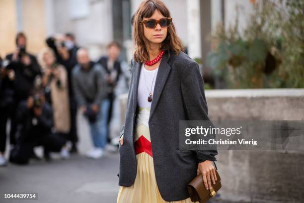 Natasha Goldenberg wearing yellow skirt, black blazer, white heels is seen outside Sacai during Paris Fashion Week Womenswear Spring/Summer 2019 on...