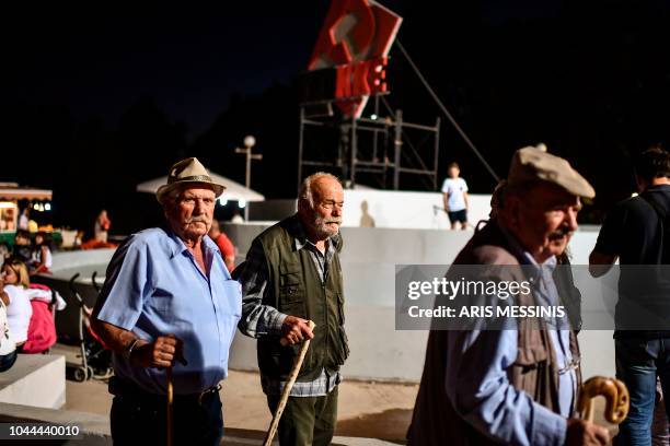 People visit an annual festival of the Greek Communist party party's youth wing in Athens on September 22, 2018. - The Greek Communist party -- KKE...