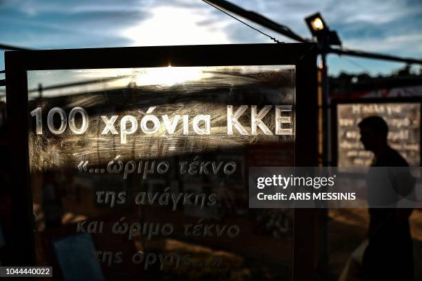 People visit an exibition for the 100 years anniversary of the Greek Communist party during an annual festival of the party's youth wing in Athens on...