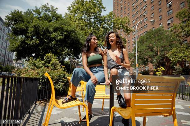 young females hanging out in city - green shoes stockfoto's en -beelden