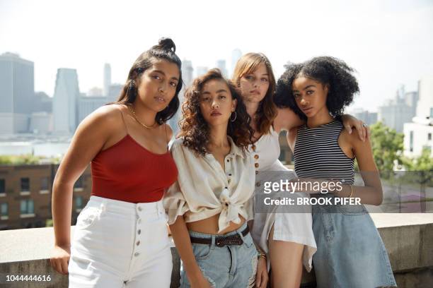 young females hanging out in city - four people stock pictures, royalty-free photos & images