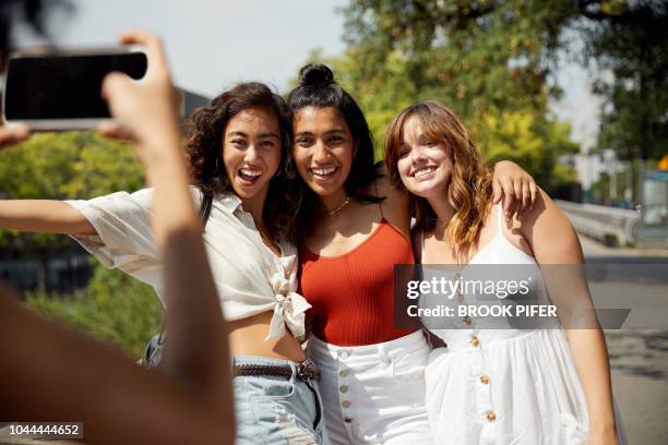 young females hanging out in city - woman in spaghetti straps stock pictures, royalty-free photos & images