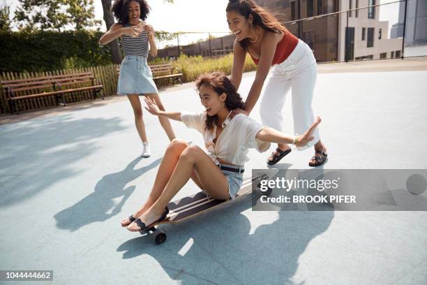 young females hanging out in city - red skirt stock pictures, royalty-free photos & images